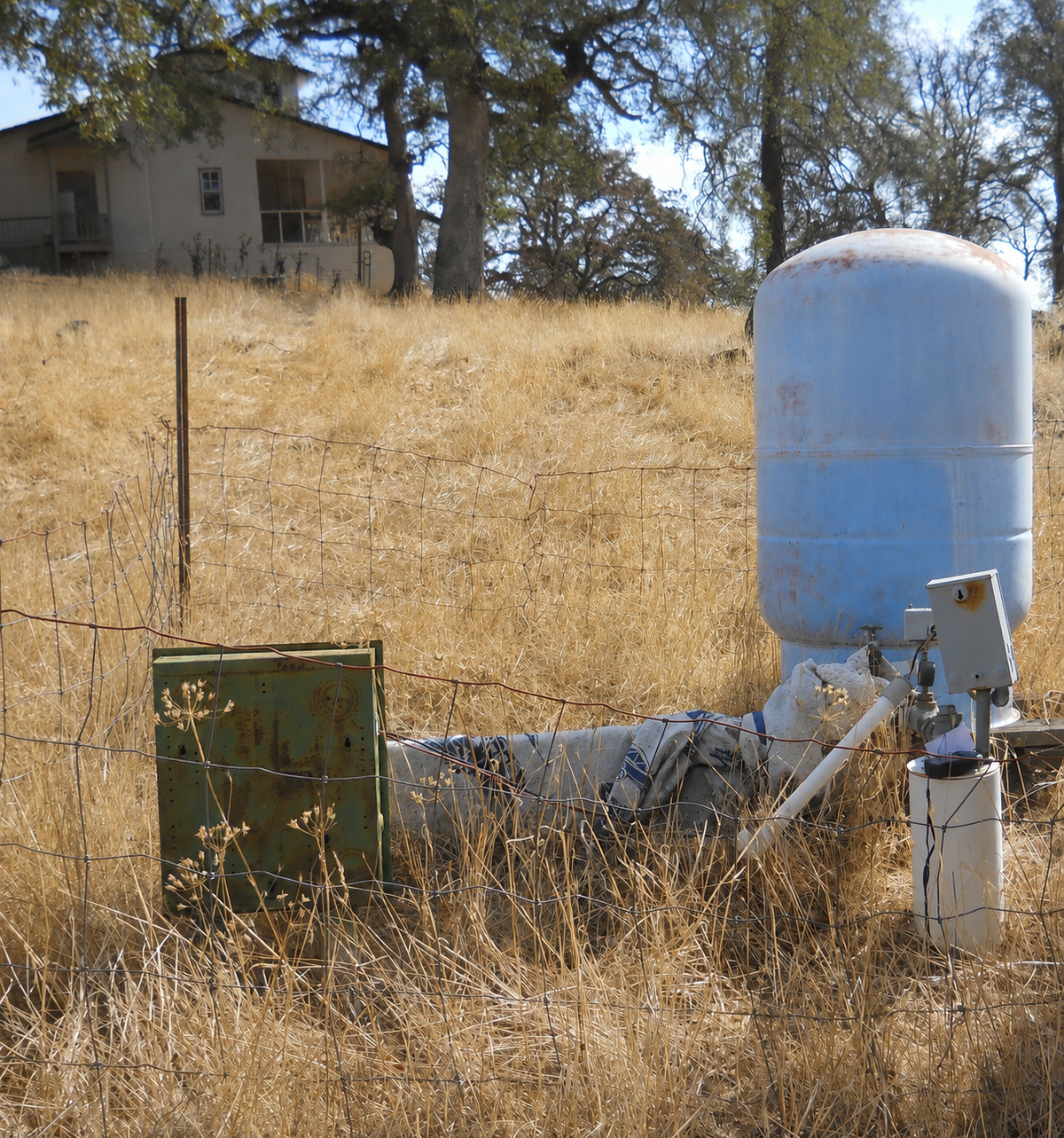 Private well pressure tank in a rural residential setting
